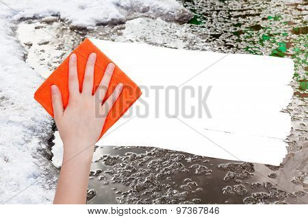 Hand Deletes Melting Snow By Orange Rag