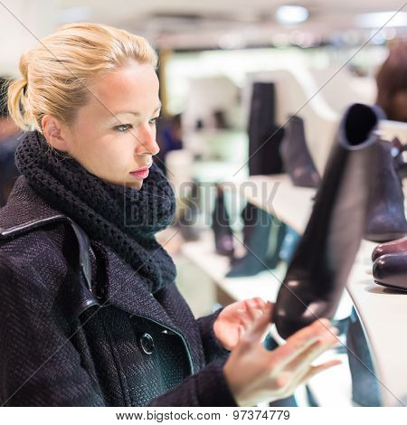 Beautiful woman shopping in shoe store.