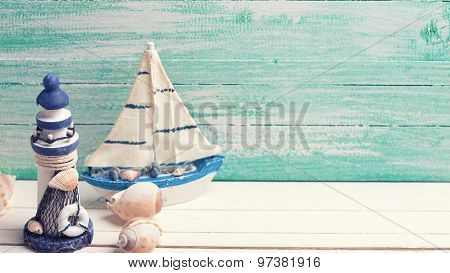 Decorative Lighthouse,  Sailing Boats And Marine Items On Wooden Background.
