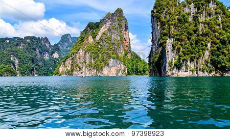 Beautiful Scene Blue Clear Water With Rock Mountain At Ratchaprapa Dam, Suratthani, Thailand