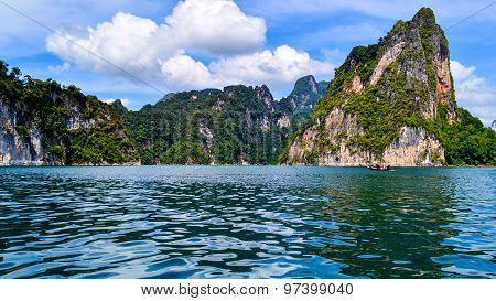Beautiful Scene Blue Clear Water With Rock Mountain At Ratchaprapa Dam, Suratthani, Thailand
