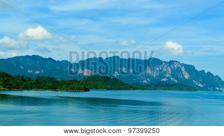 Beautiful Scene Blue Clear Water With Rock Mountain At Ratchaprapa Dam, Suratthani, Thailand