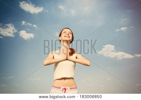 Portait Of Beautiful Young Woman Doing Joga On The Wonderful Sky Background