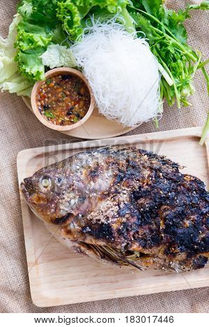 Grill salt Tilapia fish with vegetable rice noodles and spicy sauce