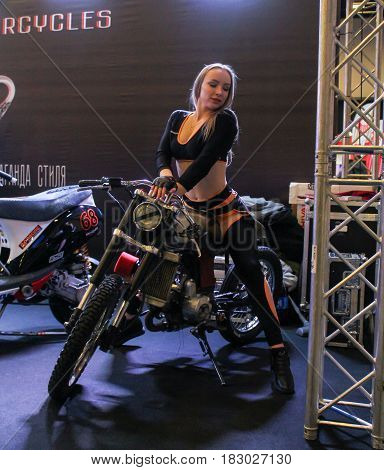 St. Petersburg Russia - 15 April, Young girl on a motorcycle,15 April, 2017.
International Motor Show IMIS-2017 in Expoforurum.
Models on motorcycles presented at the motor show.