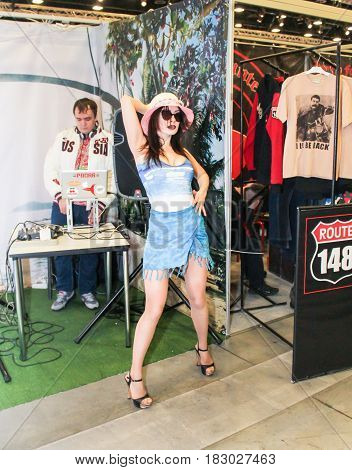 St. Petersburg Russia - 15 April, Young model in dark glasses,15 April, 2017.
International Motor Show IMIS-2017 in Expoforurum.
Erotic dances of the girls at the motor show.