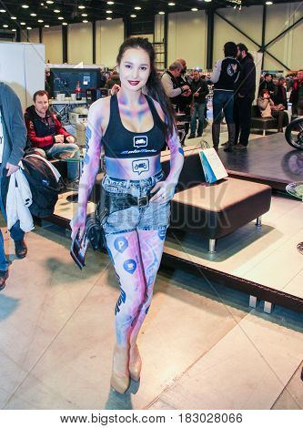 St. Petersburg Russia - 15 April, Young model with a picture on the body,15 April, 2017.
International Motor Show IMIS-2017 in Expoforurum.
Visitors and participants of the annual moto-salon in St. Petersburg.