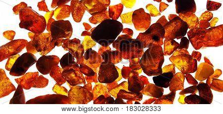 Different pieces of colorful amber on a white background