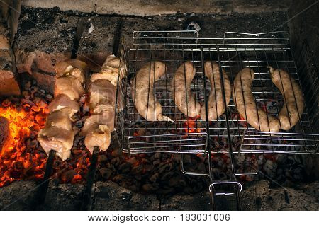 Barbecue meat and sausages on the grill coals. outdoor vacation concept close up.Top view.