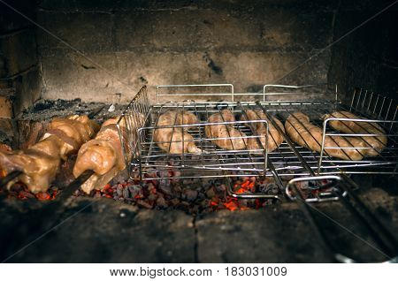 Barbecue meat and sausages on the grill coals. outdoor vacation concept. Front view.
