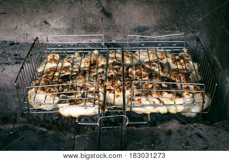 Barbecue meat steaks on the grill with flames. Meat on the coals barbecue close up.