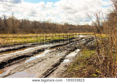 Spring landscape. Dirty spring road. Impassibility and mudslides 