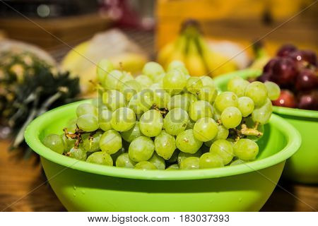 Fresh green grapes on a wooden table.