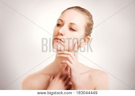 gorgeous blue eyed blonde model portrait with skin surgery mark isolated on white background