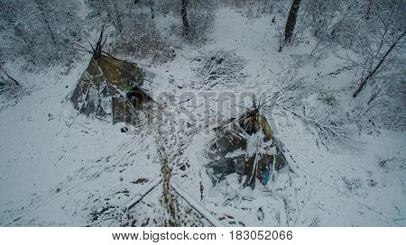 Aerial view near of Kinderlinskaya cave and village Tash-Asty on Zilim river. Life in the tipi at winter