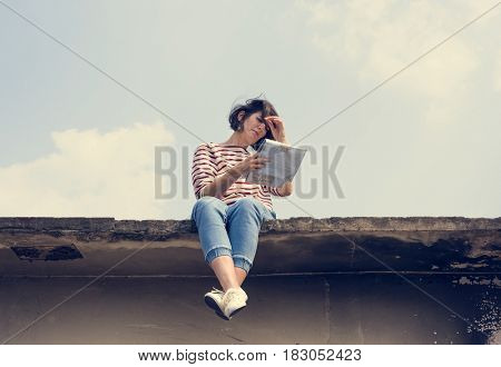 Woman sitting on deck and looking map