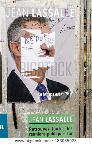 STRASBOURG FRANCE - APR 26 2017: Official campaign posters of Jean Lassalle political party leader of Resistons vandalized on the first round of 2017 French presidential election
