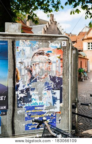 STRASBOURG FRANCE - APR 23 2017: Official campaign posters of Marine Le Pen political party leader of Front national (FN) vandalized on the first round of 2017 French presidential election