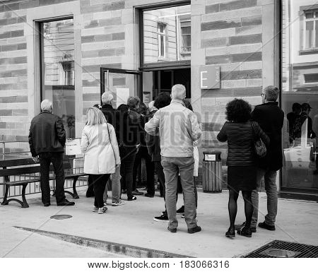 STRASBOURG FRANCE - APR 23 2017: People queue to vote in the first round of the French presidential election in the city of Strasbourg France Alsace