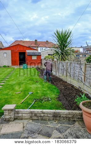 Doing the garden in Spring. Portrait shot of man digging.