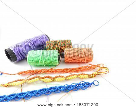 Yarns of different colors and bracelets made by hand.