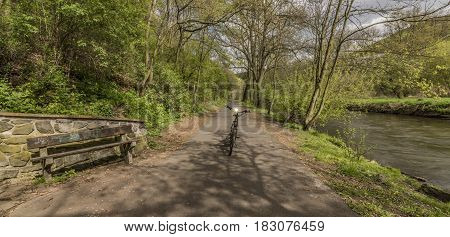 Electric bicycle with Bilina river in sunny spring day