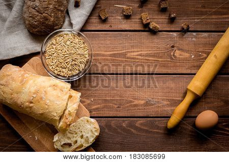 bakery concept with homemade fresh wheat bread on rustic kitchen table background top view moke-up
