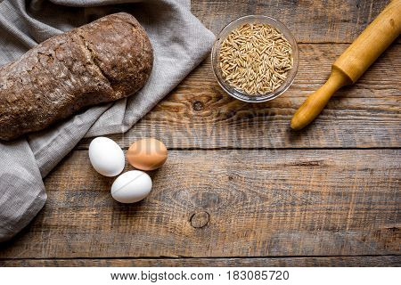 bakery concept with homemade fresh rye bread on rustic kitchen table background top view moke-up