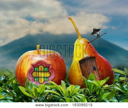 Surreal photo manipulation of a pear and apple fantasy house with door, window, lamp post, and a volcano in the background