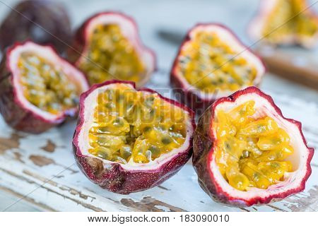 ripe organic passion fruits on white wooden background