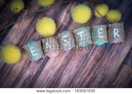 Easter concept: inscription Easter consisting on sacking and copy space. wooden background