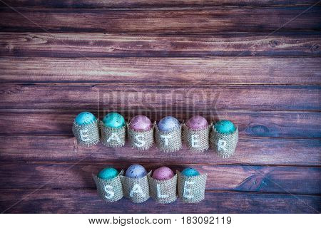 Easter concept: inscription Easter sale consisting on sacking. On wooden background waith copy space