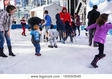 parent and kids enjoy snow festival taken in Sydney Australia on 6 July 2016