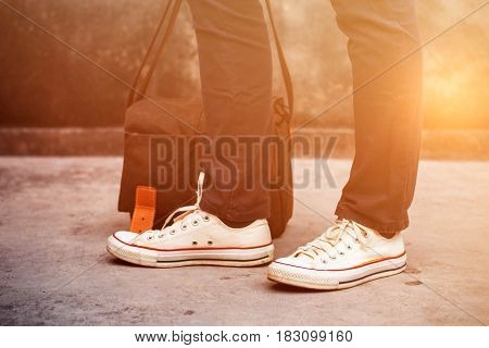 Fashion sneakers with pockets on the concrete.