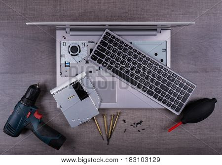 Computer Notebook With Coponent And Tool (repair Concept) On Wood Background