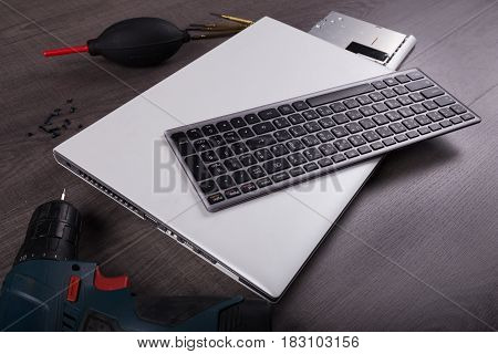 Computer Notebook With Coponent And Tool (repair Concept) On Wood Background