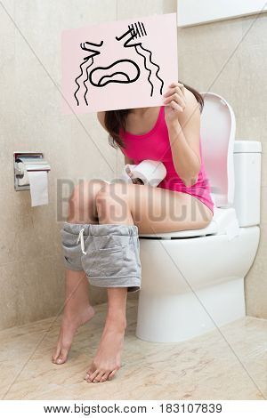 woman take cry billboard with constipation in the bathroom