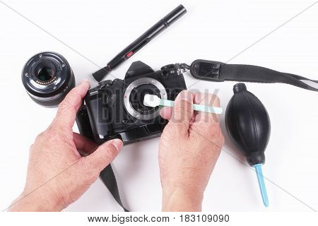 Mirrorless Sensor cleaning and MaintenancePhotographer hand cleaning sensor of camera by using sensor swab and vacuum pumpcleaning dirty camera sensor (CCD or Cmos)