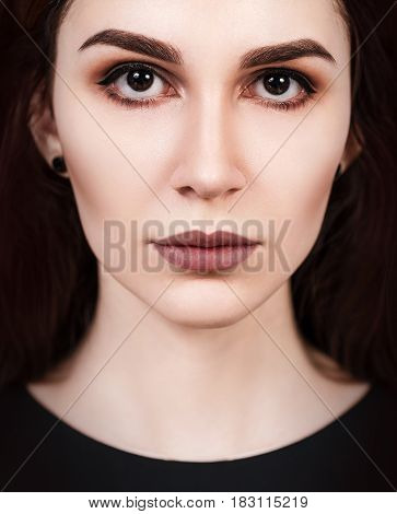 Close-up portrait of young beautiful woman's face with eloquent eyes.