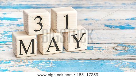 May 31st. Wooden cubes with date of 31 May on old blue wooden background.