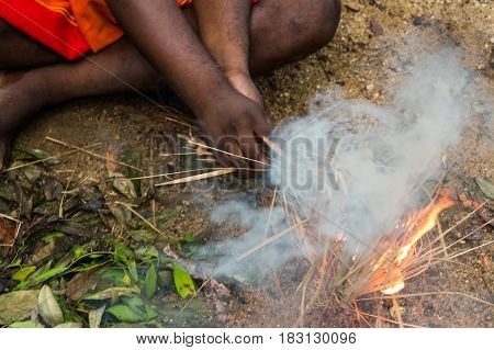 DABANA, SRI LANKA - CIRCA DECEMBER 2016: Vedda men making fire. Veddas are an indigenous people of Sri Lanka living in tribes in the jungle
