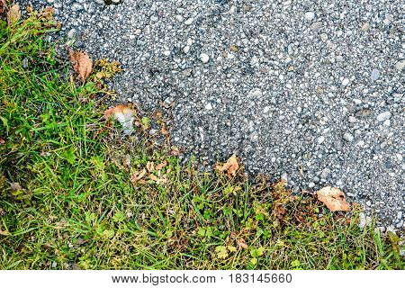 Line Between Grass And Asphalt Outside On The Road Texture.