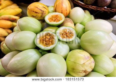Traditional market stall full of fresh yellow maracujas