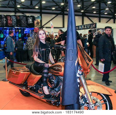 St. Petersburg Russia - 15 April, A girl is posing on a big motorcycle,15 April, 2017.
International Motor Show IMIS-2017 in Expoforurum.
Models on motorcycles presented at the motor show.