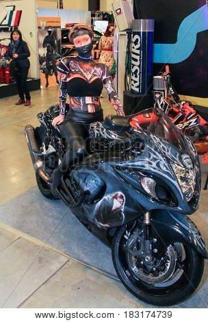 St. Petersburg Russia - 15 April, A fashion model at a motor show,15 April, 2017.
International Motor Show IMIS-2017 in Expoforurum.
Models on motorcycles presented at the motor show.