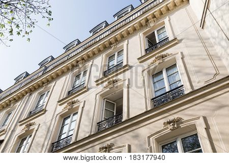 Paris, France, March 26, 2017: View on narrow cobbled street among traditional parisian buildings in Paris, France.