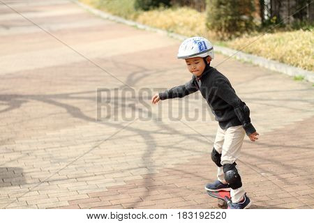 Japanese Boy Riding On A Casterboard (first Grade At Elementary School)