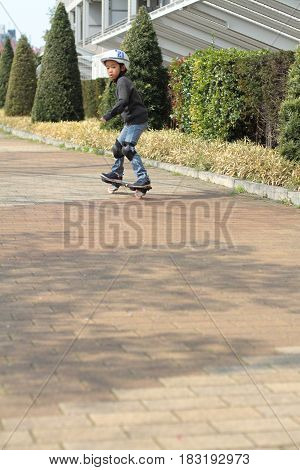 Japanese Boy Riding On A Casterboard (first Grade At Elementary School)