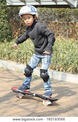 Japanese Boy Riding On A Casterboard (first Grade At Elementary School)