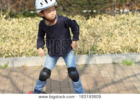 Japanese Boy Riding On A Casterboard (first Grade At Elementary School)